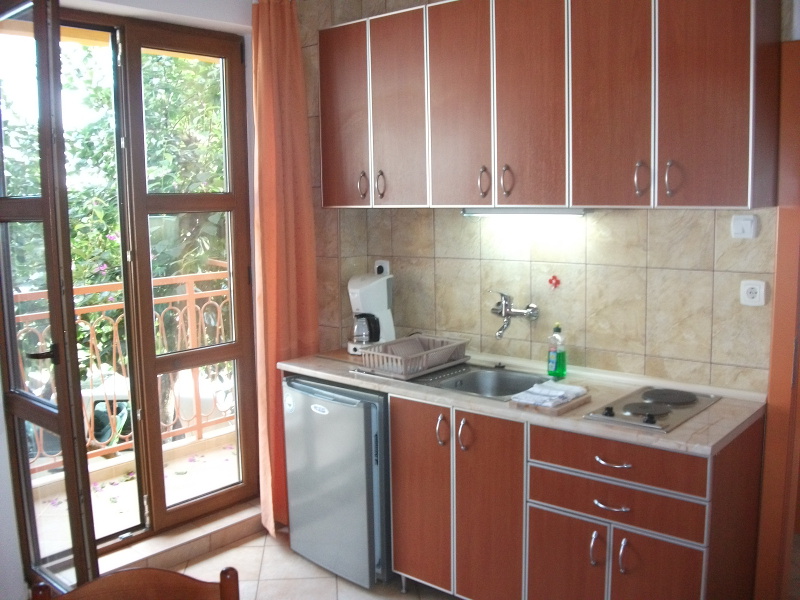 The kitchen of the apartment number 2 with a balcony. The kitchen is equipped basically.