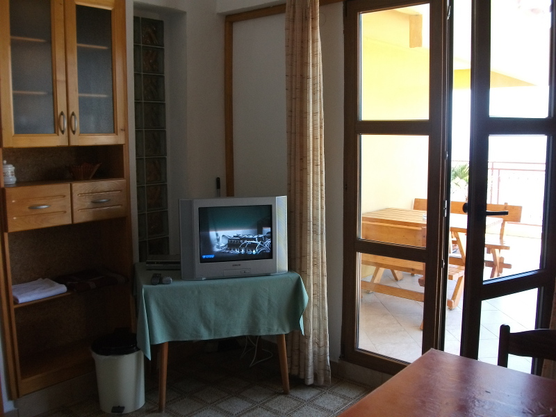 This is the kitchen of this apartment located on the second floor with satellite TV. Kitchen is equipped basically.